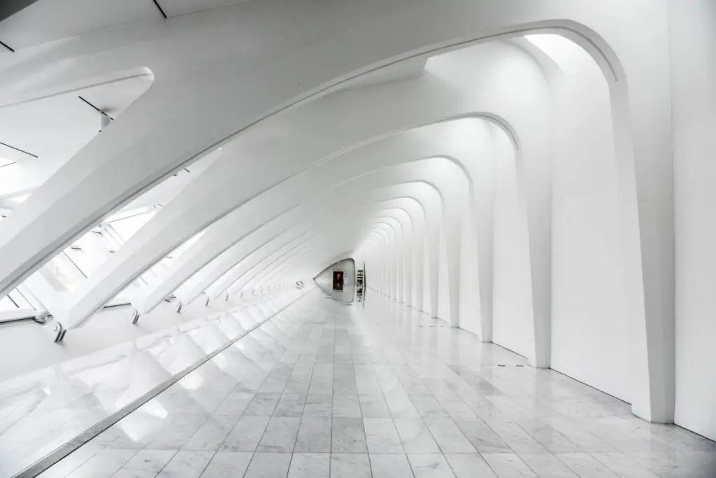 Futuristic white architectural hallway with arches.