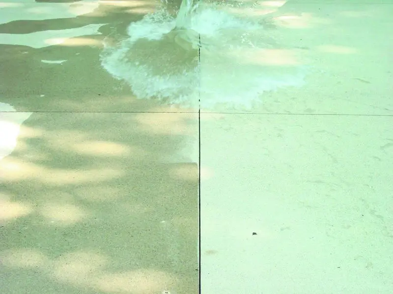 Water splashing on light-colored tiled surface.