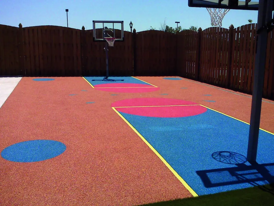 Colorful outdoor basketball court with geometric designs.