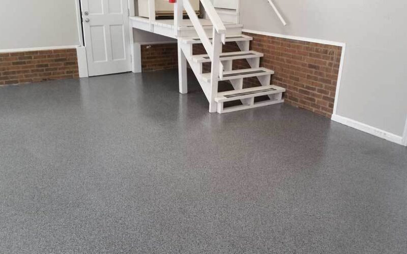 Garage interior with gray speckled floor.