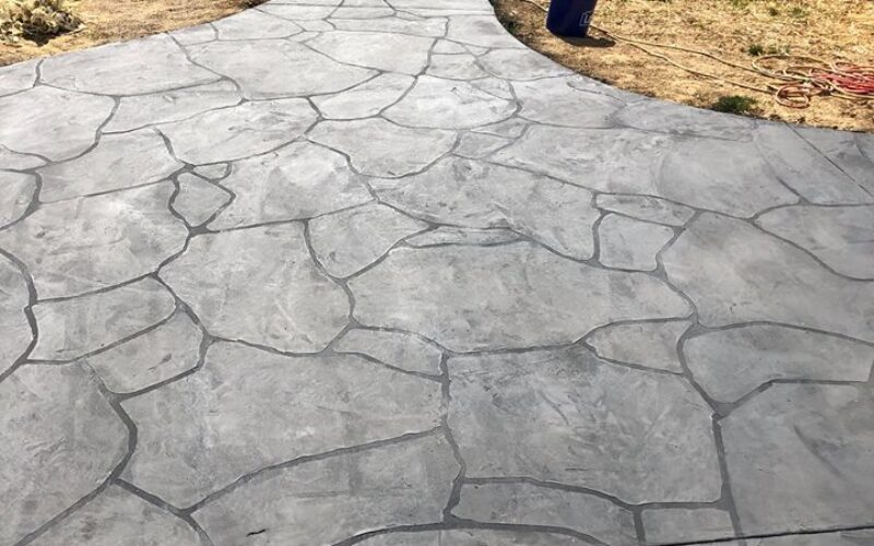 Stone pathway leading to fenced area.