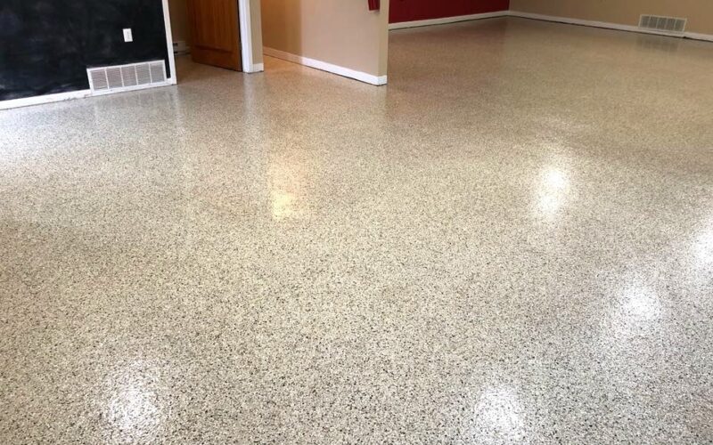 Empty room with polished speckled flooring.