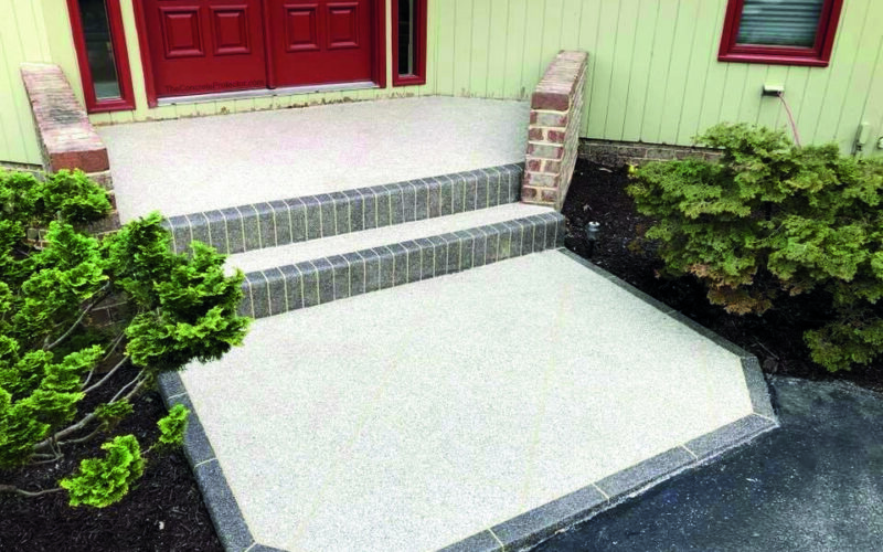 Front steps with red door and plants.