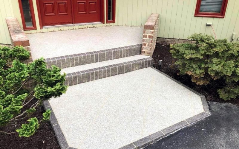 Front steps with red door and plants.